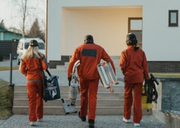 cleaning crew walking toward house