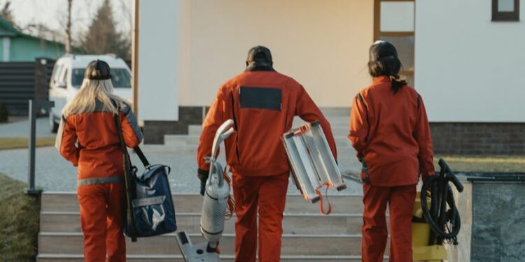 cleaning crew walking toward house