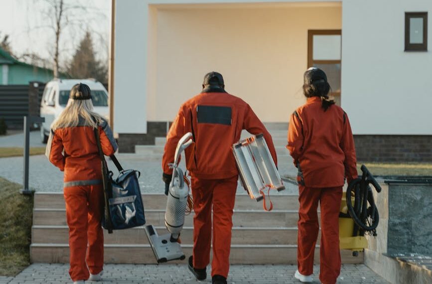 cleaning crew walking toward house