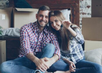 happy couple holding keys in new home
